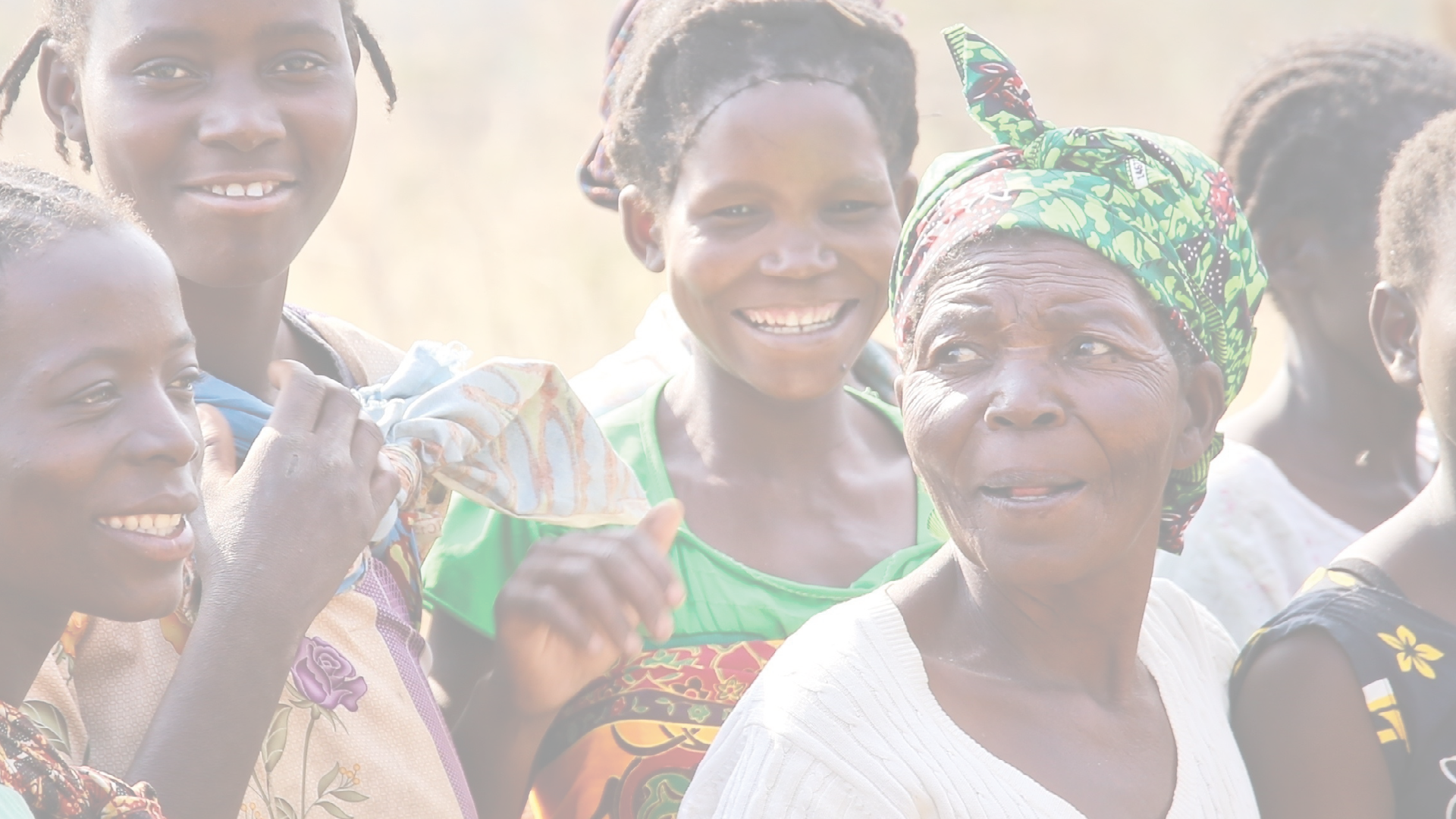 MALAWI, AFRICA, CIRCA SEPTEMBER 2017: A group of colorfully dressed African women and babies gather at a clean water pump