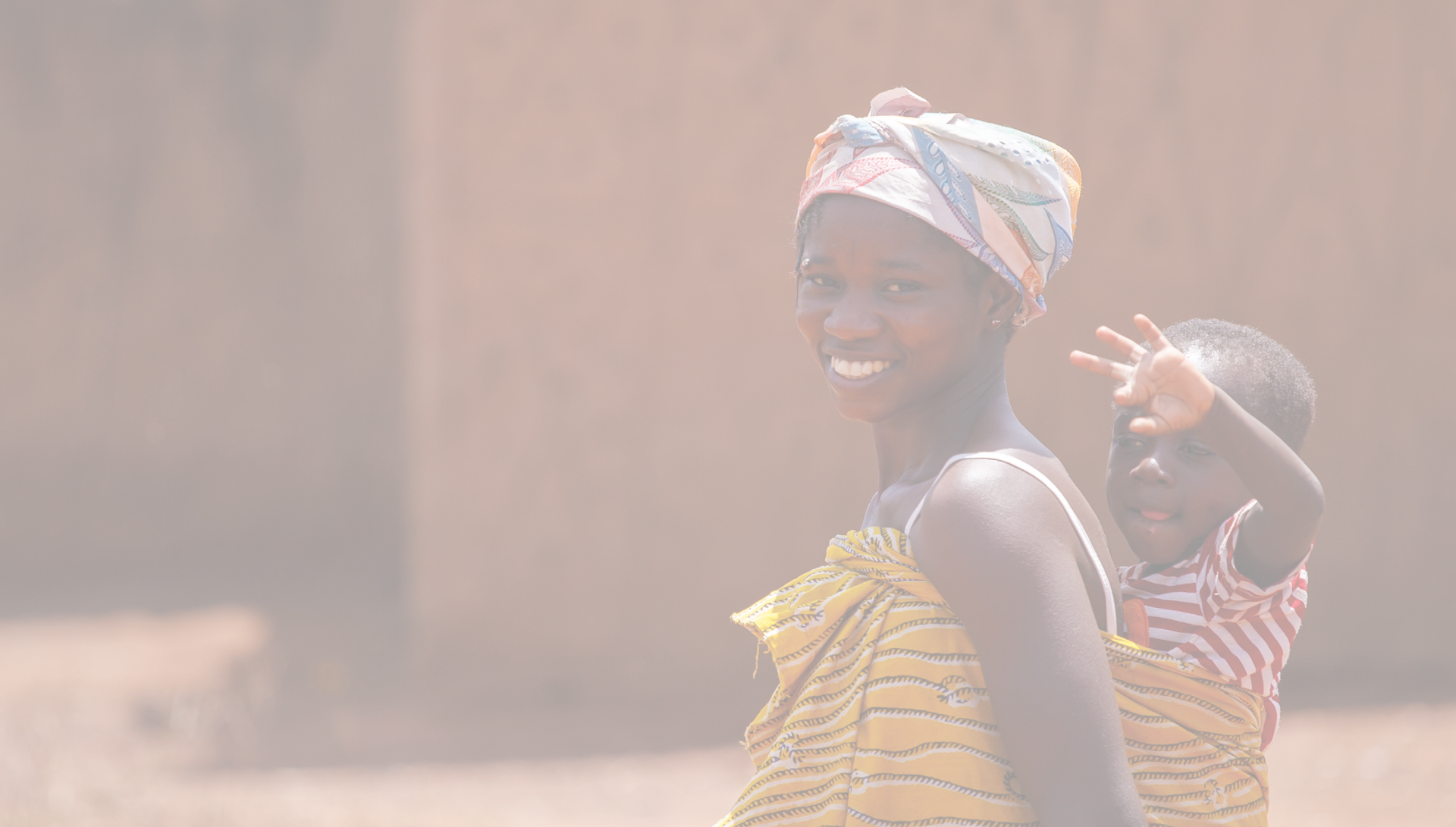 TAMALE, GHANA - MARCH 24: Unidentified African woman carrying her son on back on March 24, 2014 in Tamale, Ghana. Ghana is one of the most popular tourists destination in Africa.
